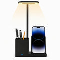 3-in-1 wireless charging desk stand with LED lamp and pen holder, charging a smartphone